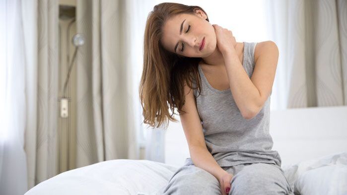 A woman is experiencing acute pain in the back of her neck.